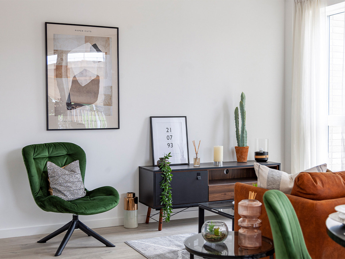 Stylish living room with green chair, abstract art, and modern decor