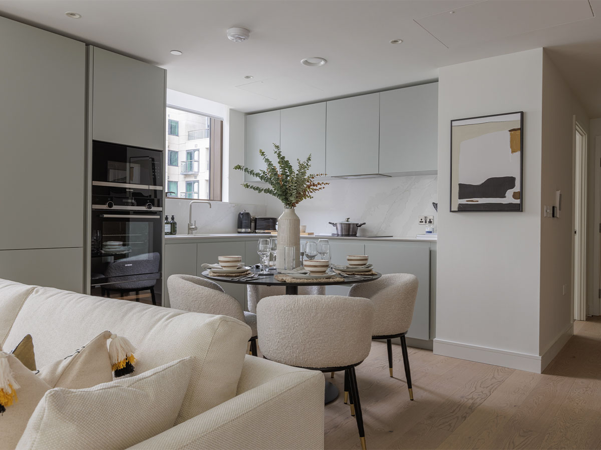 Contemporary open kitchen with a round dining table and cozy seating of Harcourt Gardens