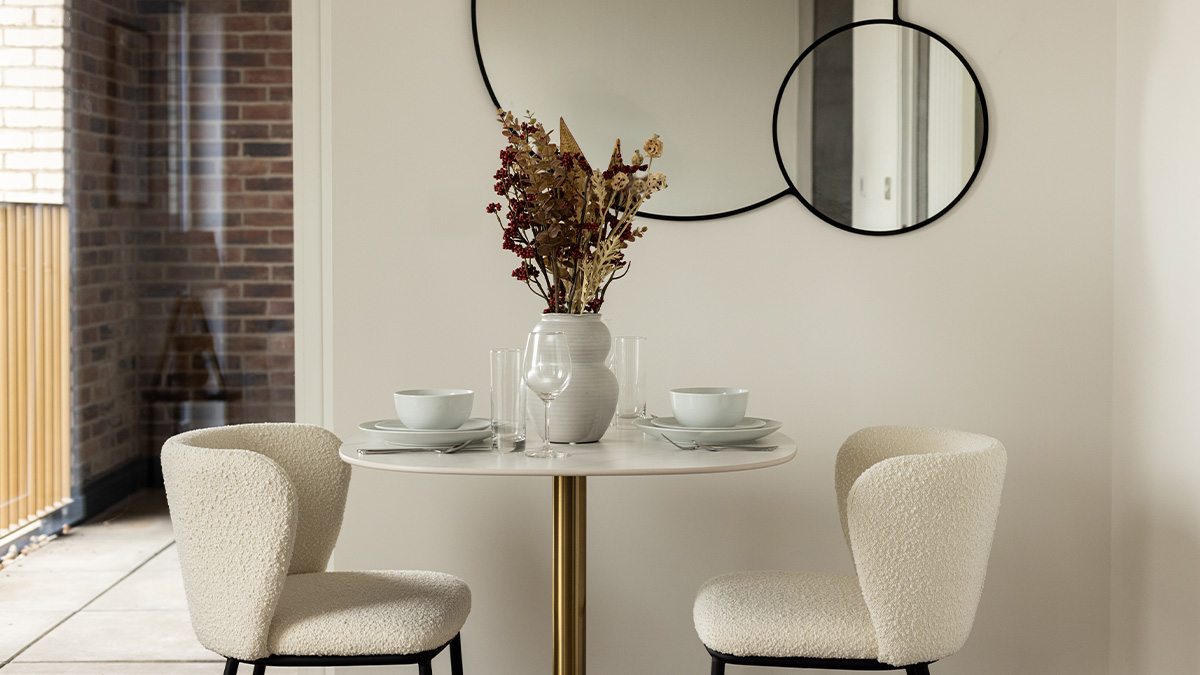 Dining table with white bowl and flower vase of Coronation Square