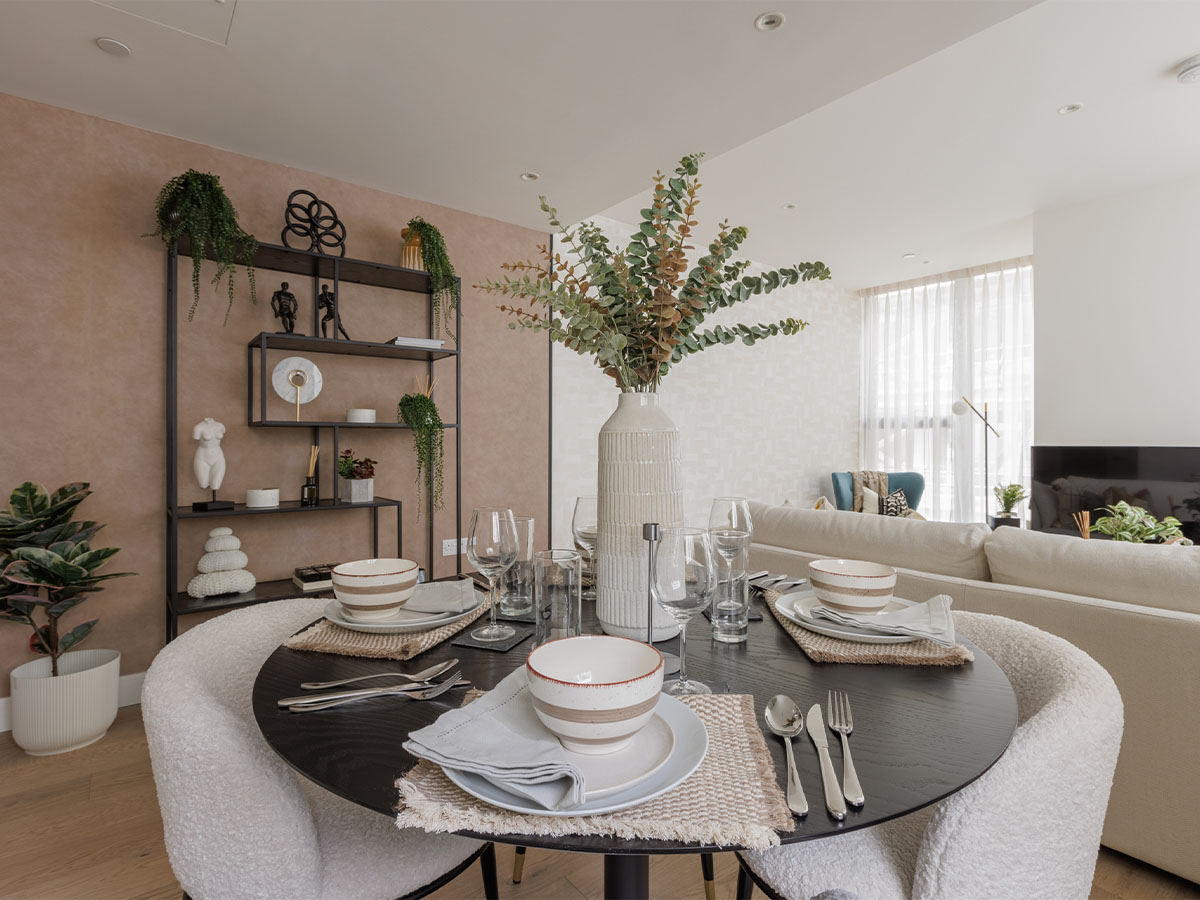 Elegant dining setup with glassware, ceramic bowls, and decorative shelving of Harcourt Gardens