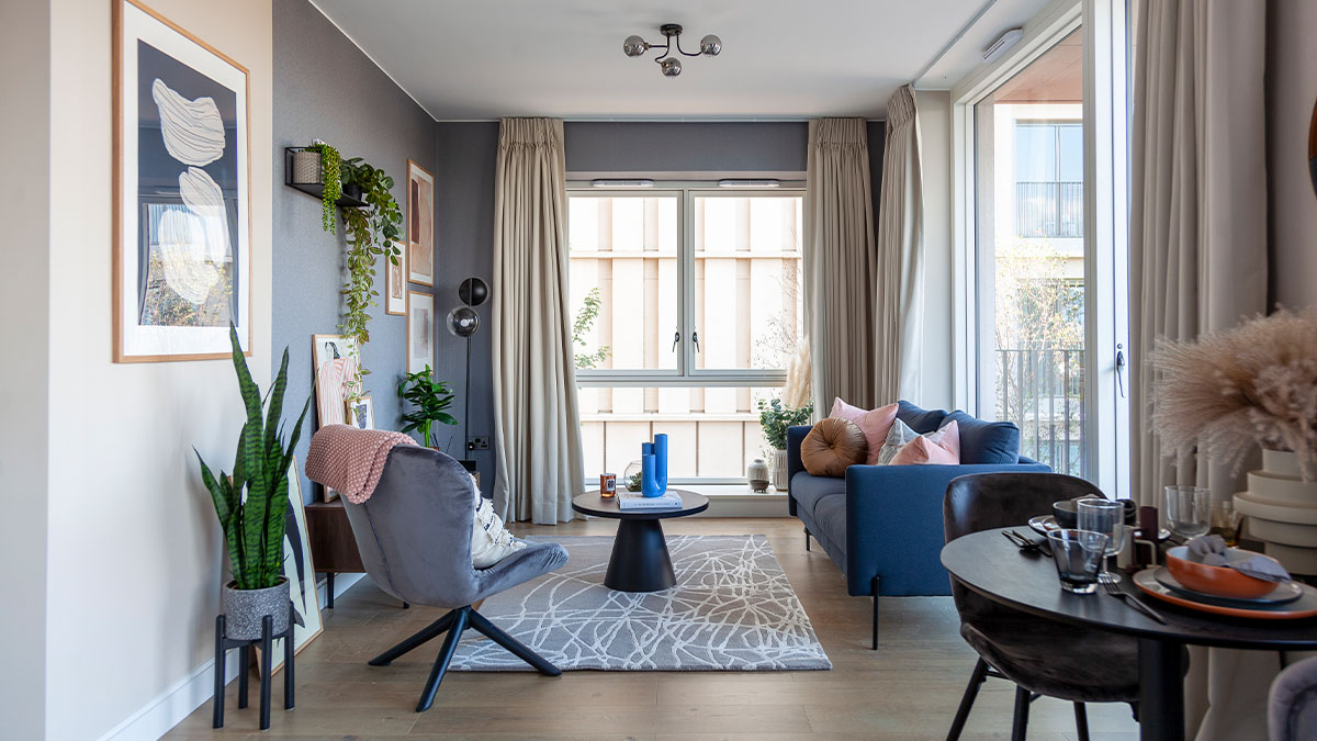 Living room with blue sofa, wall decor with window dressing