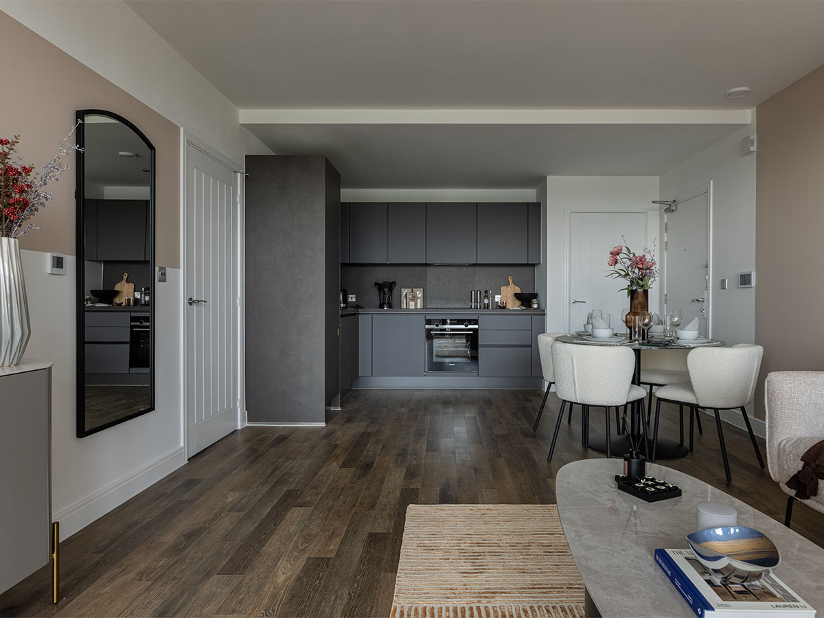 Open-plan kitchen and dining area with grey cabinets and neutral-toned furnishings of Coronation Square