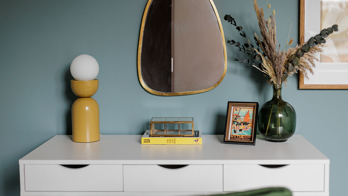 Wall decor and white table with flower vase Bowen House