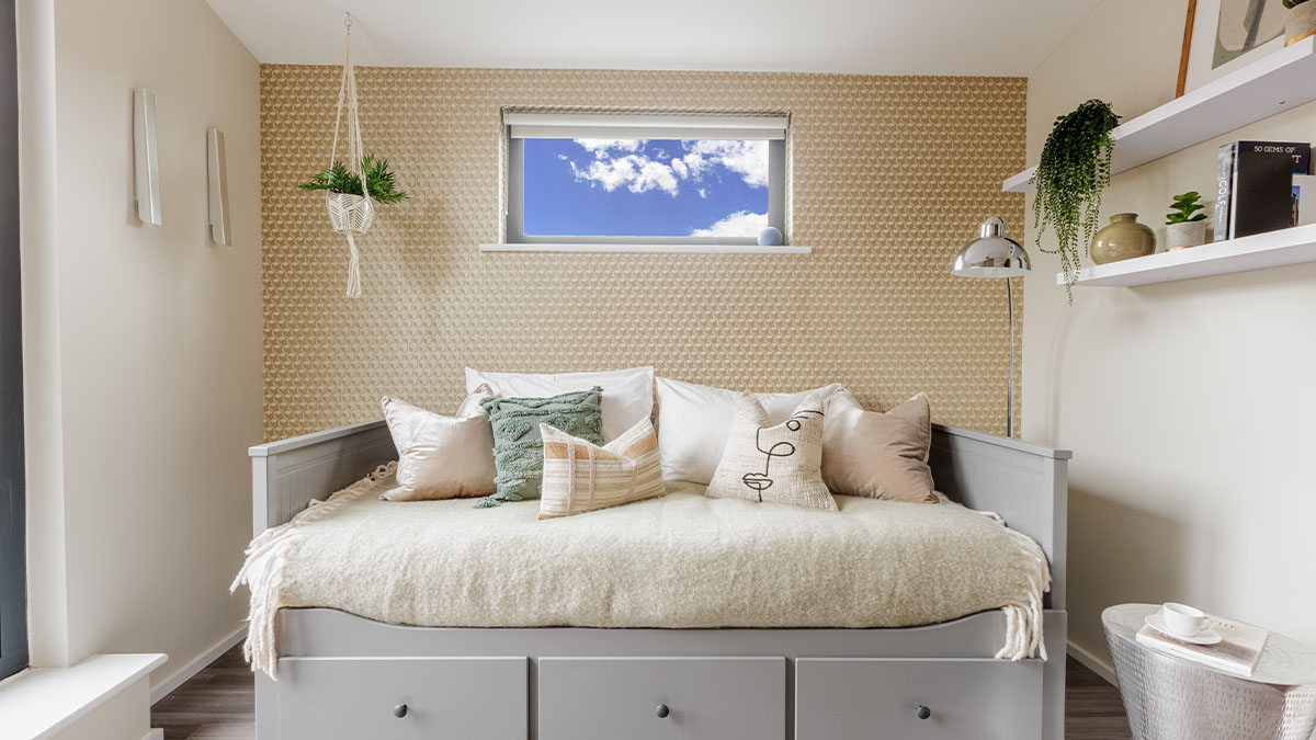 bedroom with a neutral color palette and hanging plant of Bowen House