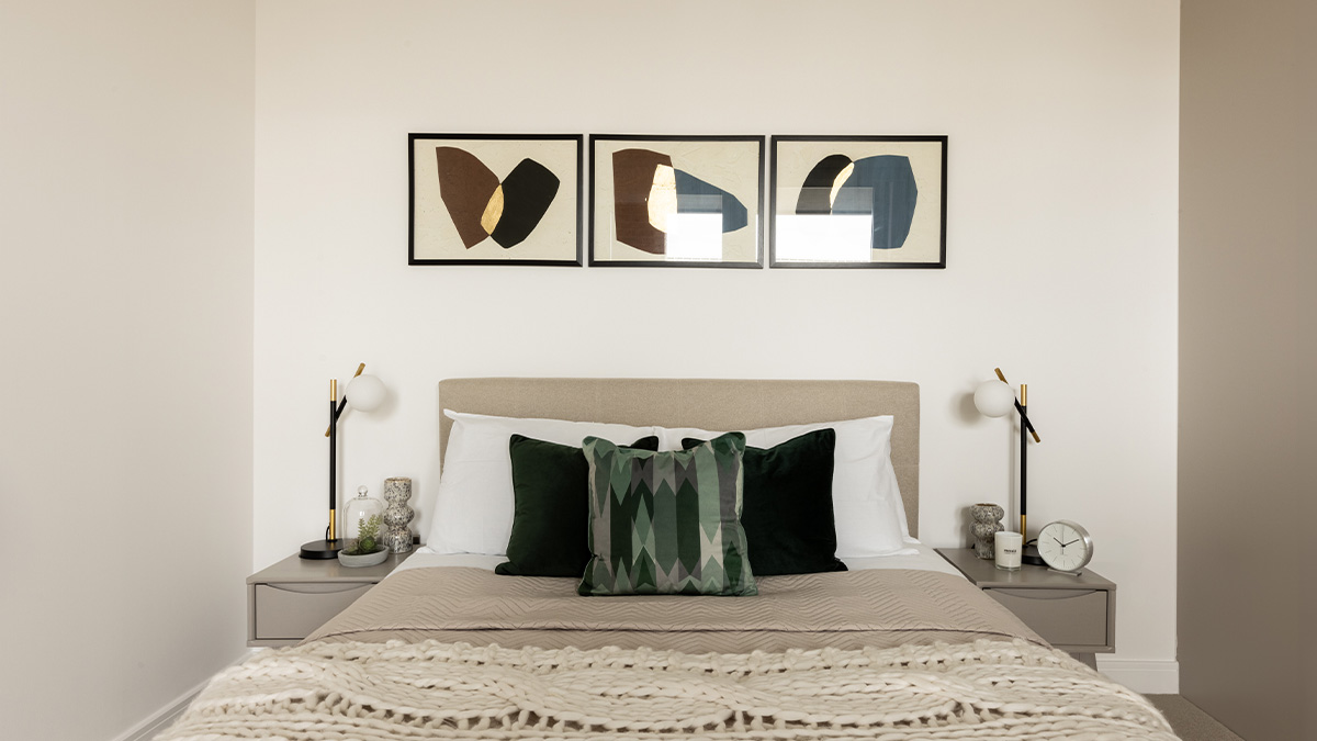 cozy bedroom with side table with clock and vase of Coronation Square