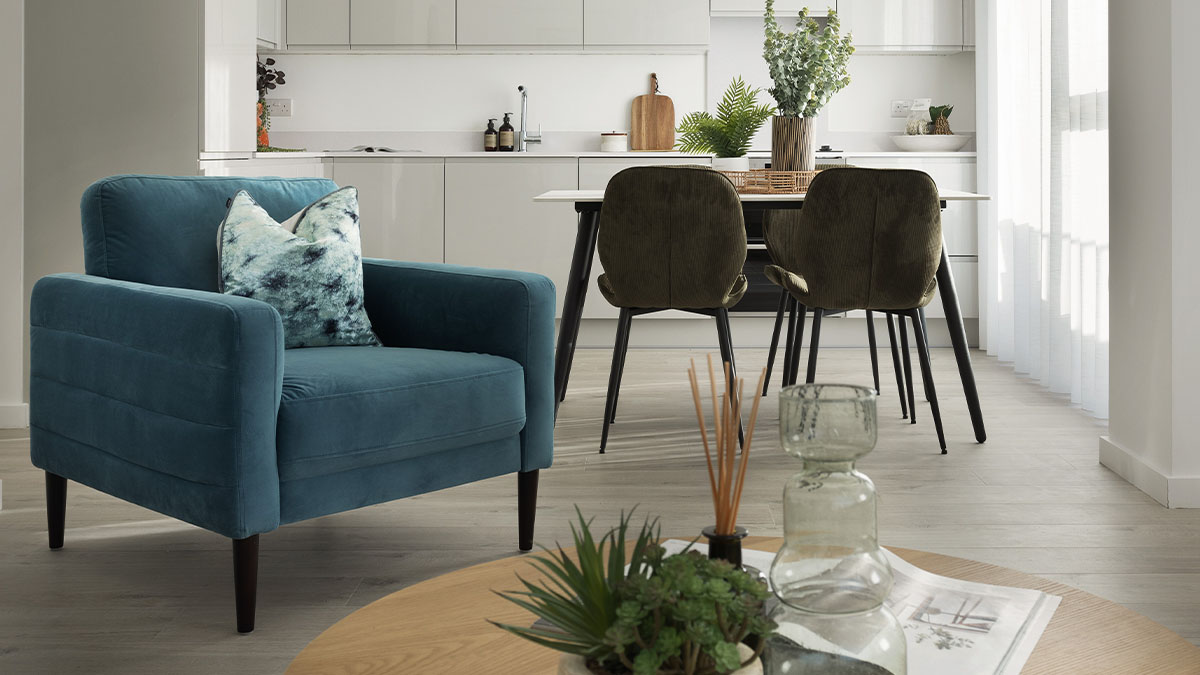 kitchen with dining table and blue sofa