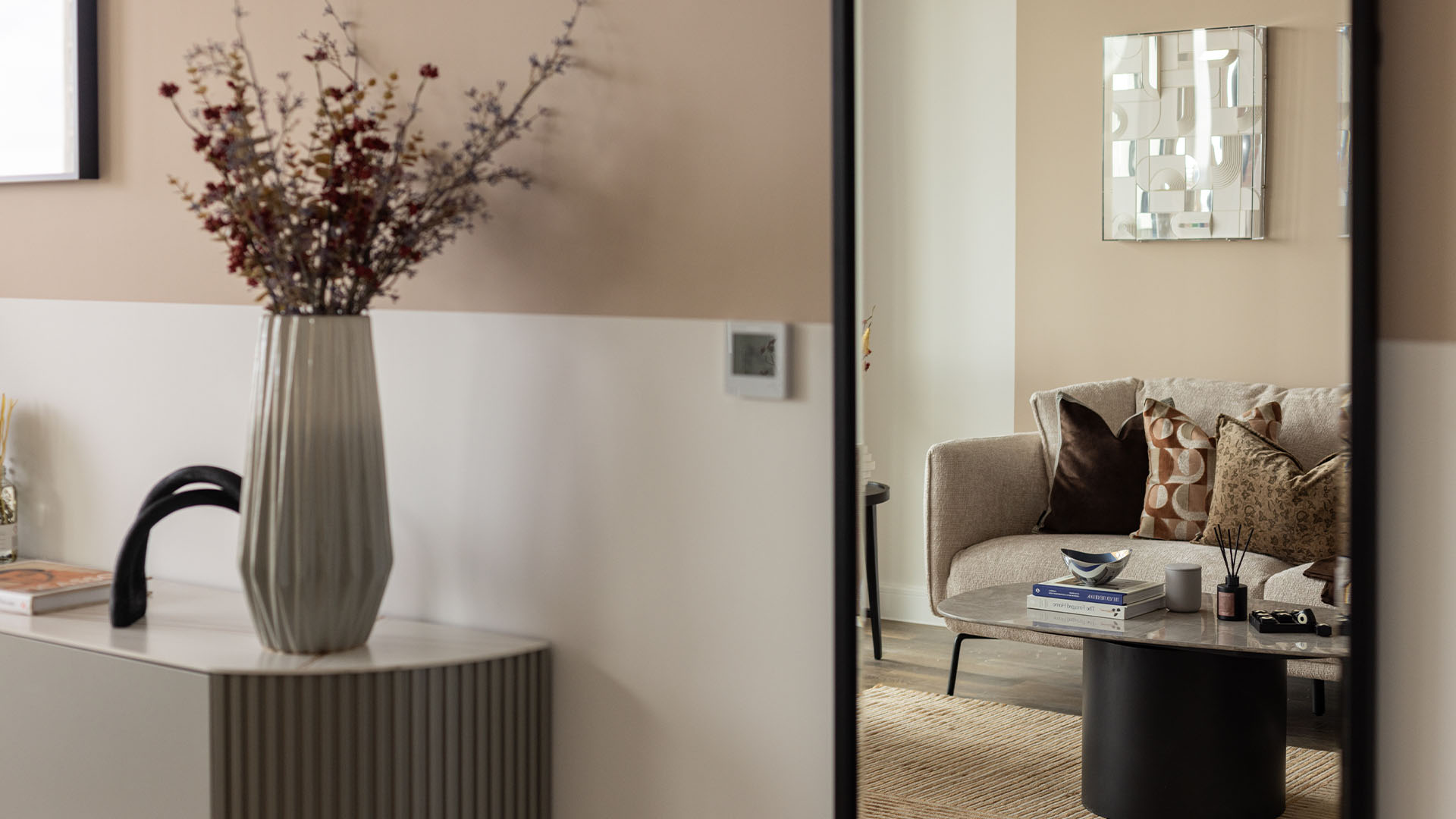 living space with a large vase holding dried flowers of Coronation Square