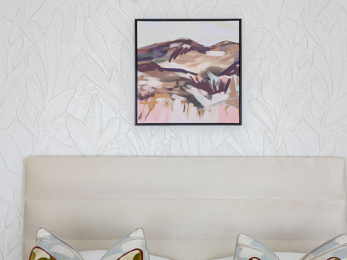 Abstract landscape painting above a bed with pillows of 9 Milbank 