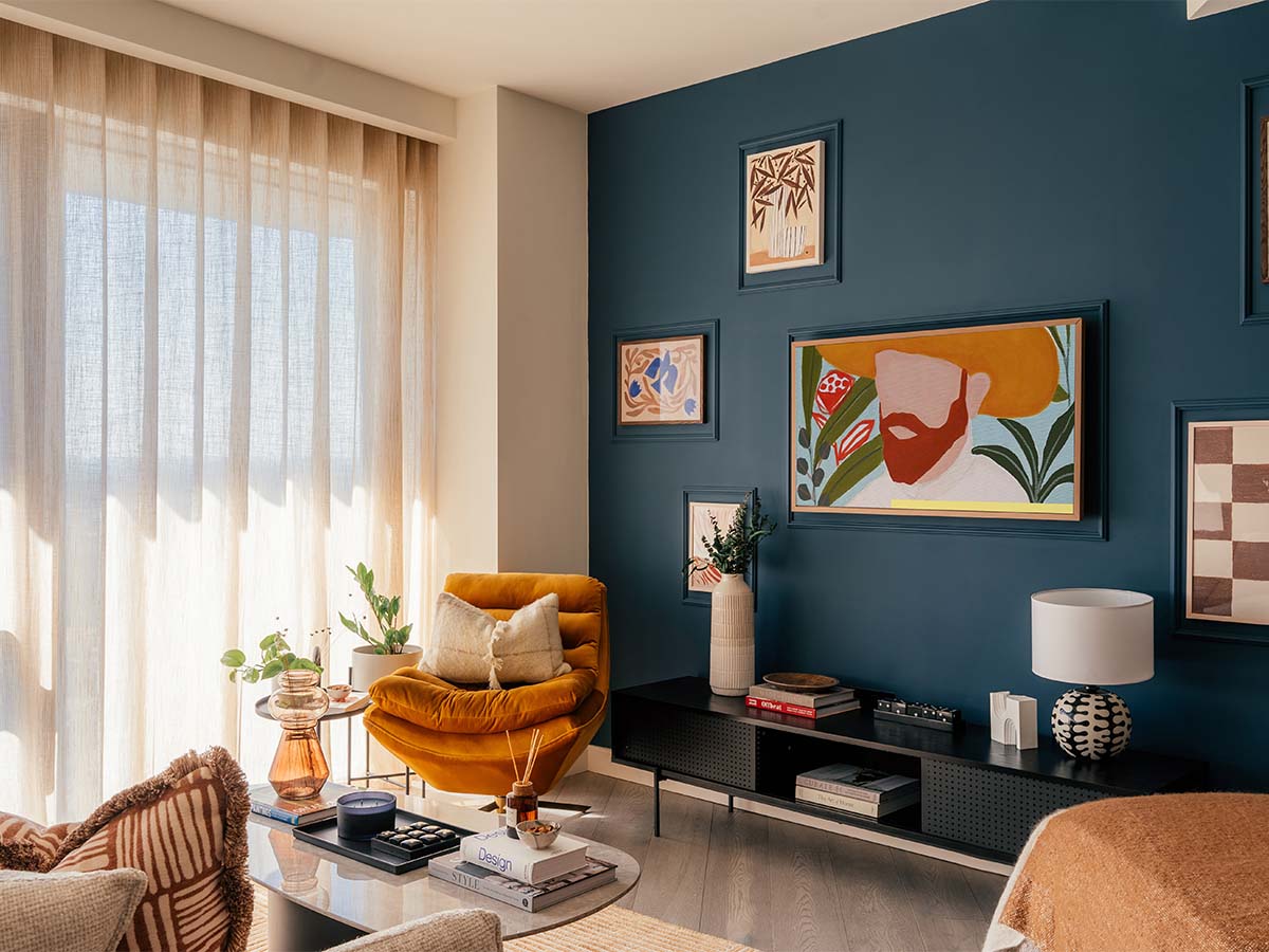 Living room with decorated wall, sofa and table of Aspen Studio