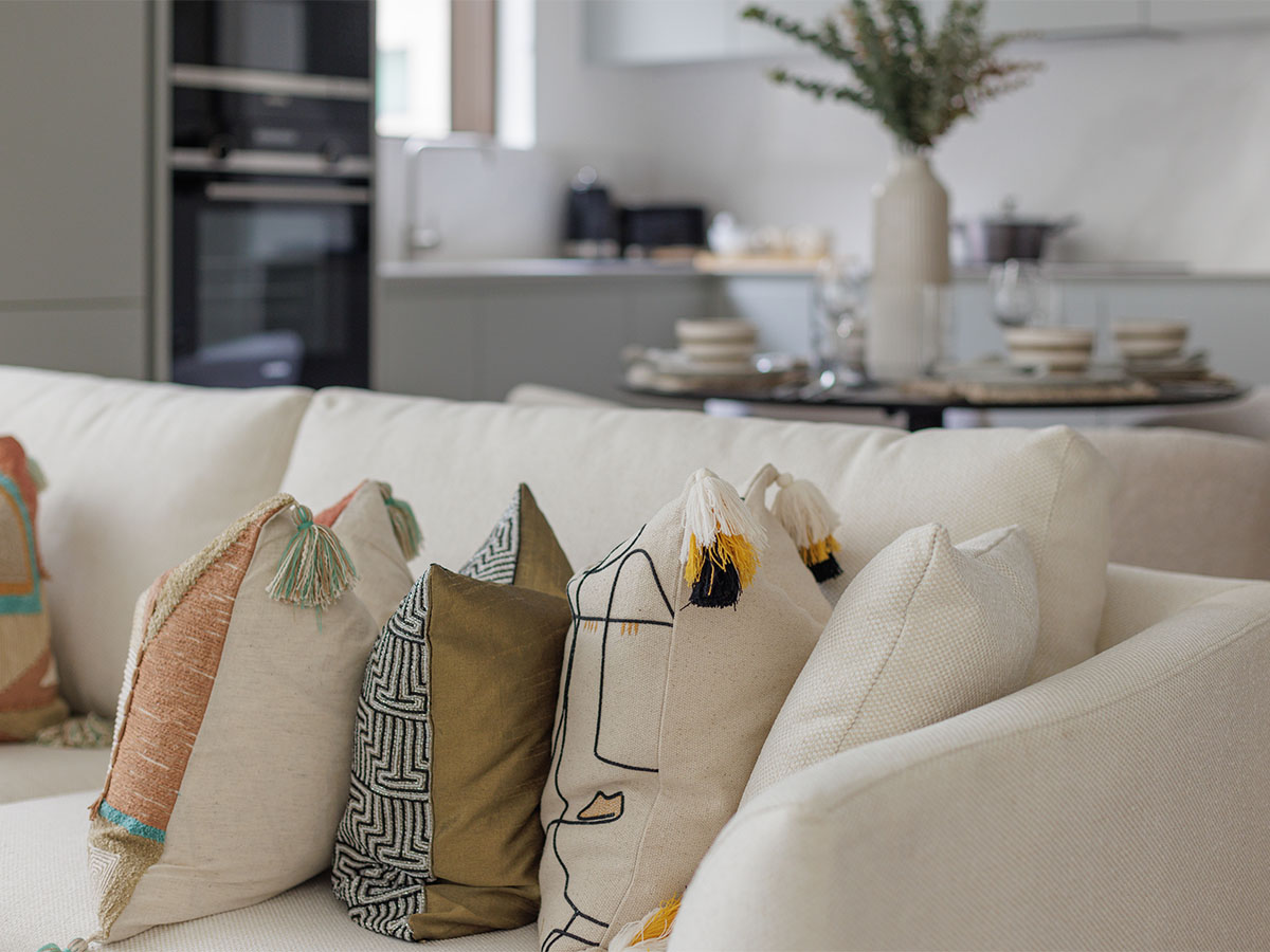 Living room with white couch and colorful pillows of Harcourt Gardens