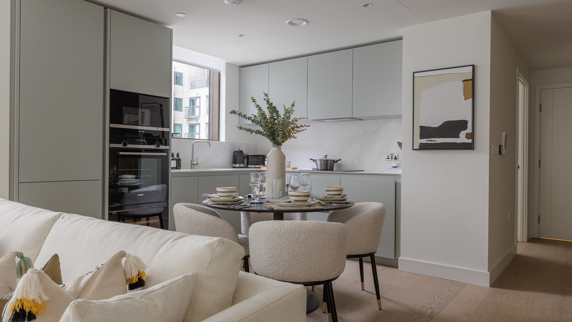 Modern kitchen and dining area with minimalist decor and neutral tones of Harcourt Gardens-29