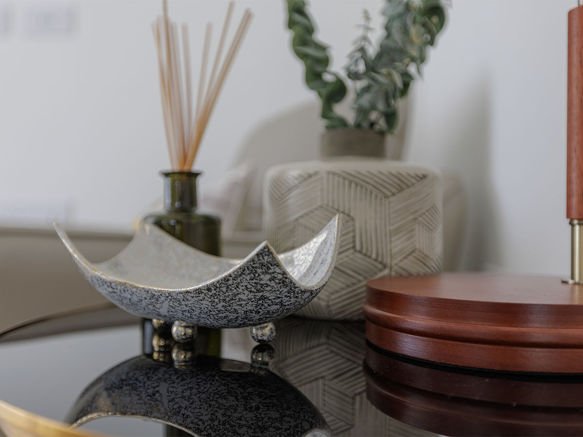 Stylish home decor with a decorative tray, vase, and plant of Beeley