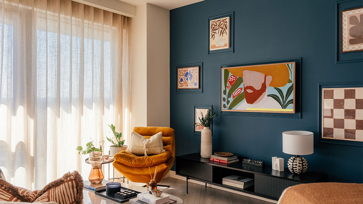 living area with bold blue accent wall, artwork, and cozy seating Aspen