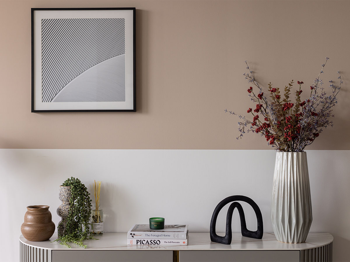 Modern living room with artwork and vase of Coronation Square