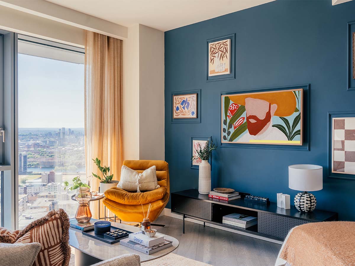 Modern living room with blue wall and yellow armchair of Aspen Studio