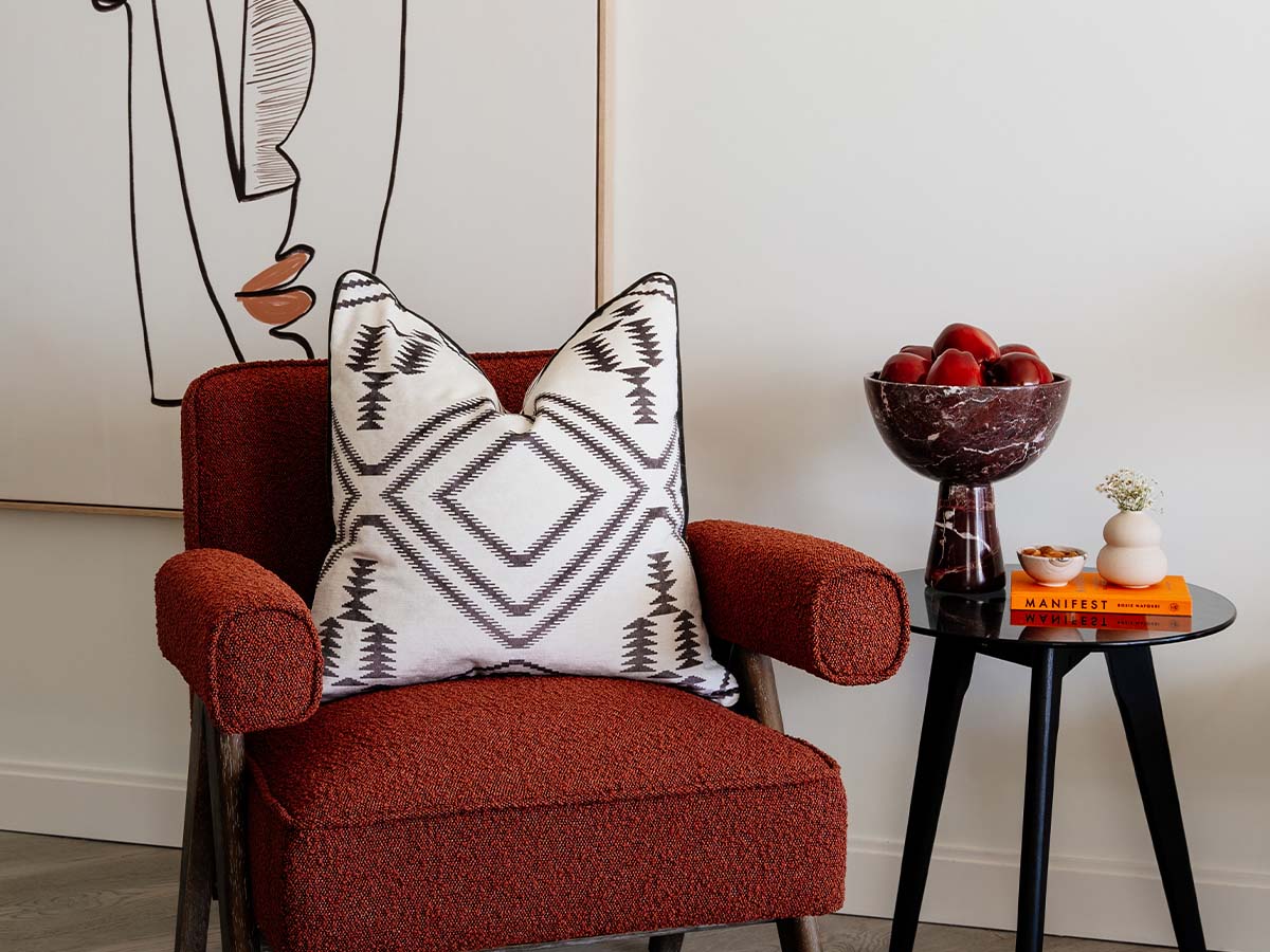 Red armchair with patterned pillow of Aspen