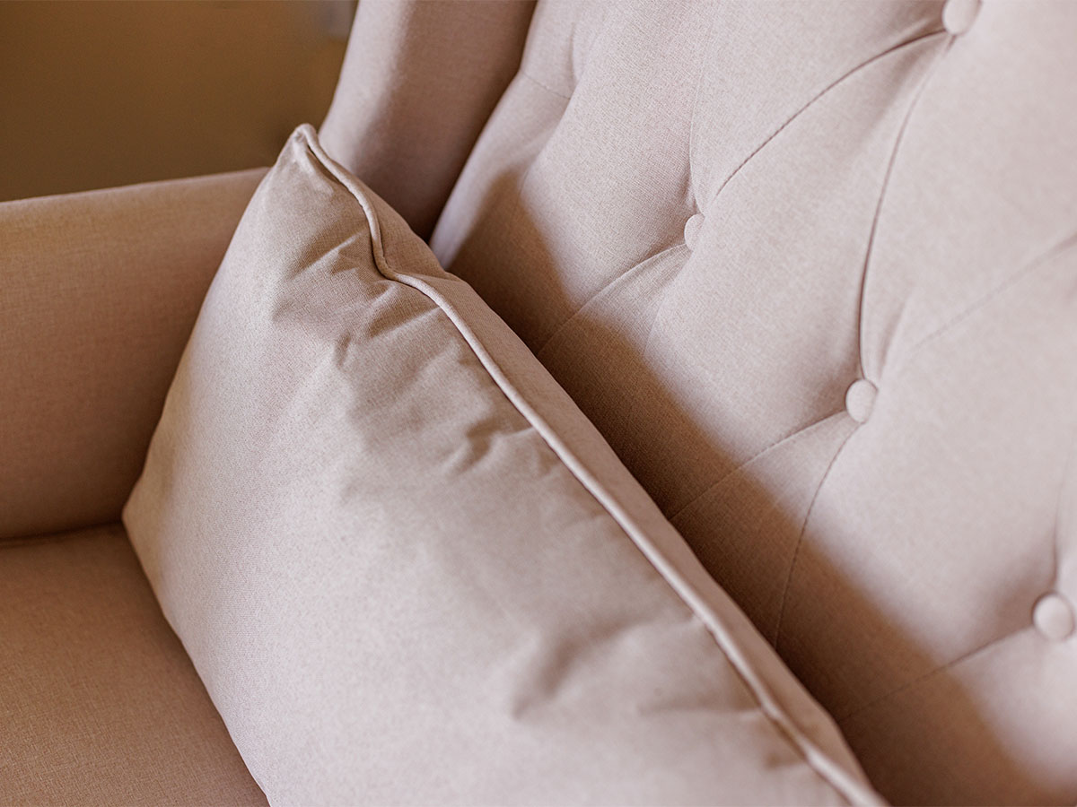 Close-up of a soft, tufted armchair