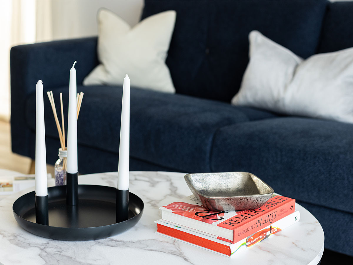 White candles and decor on marble coffee table