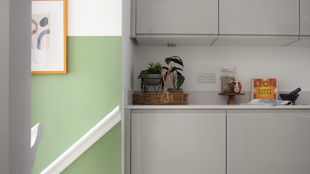 Gallions Place, Kitchen counter with plants, a cookbook, and kitchen utensils