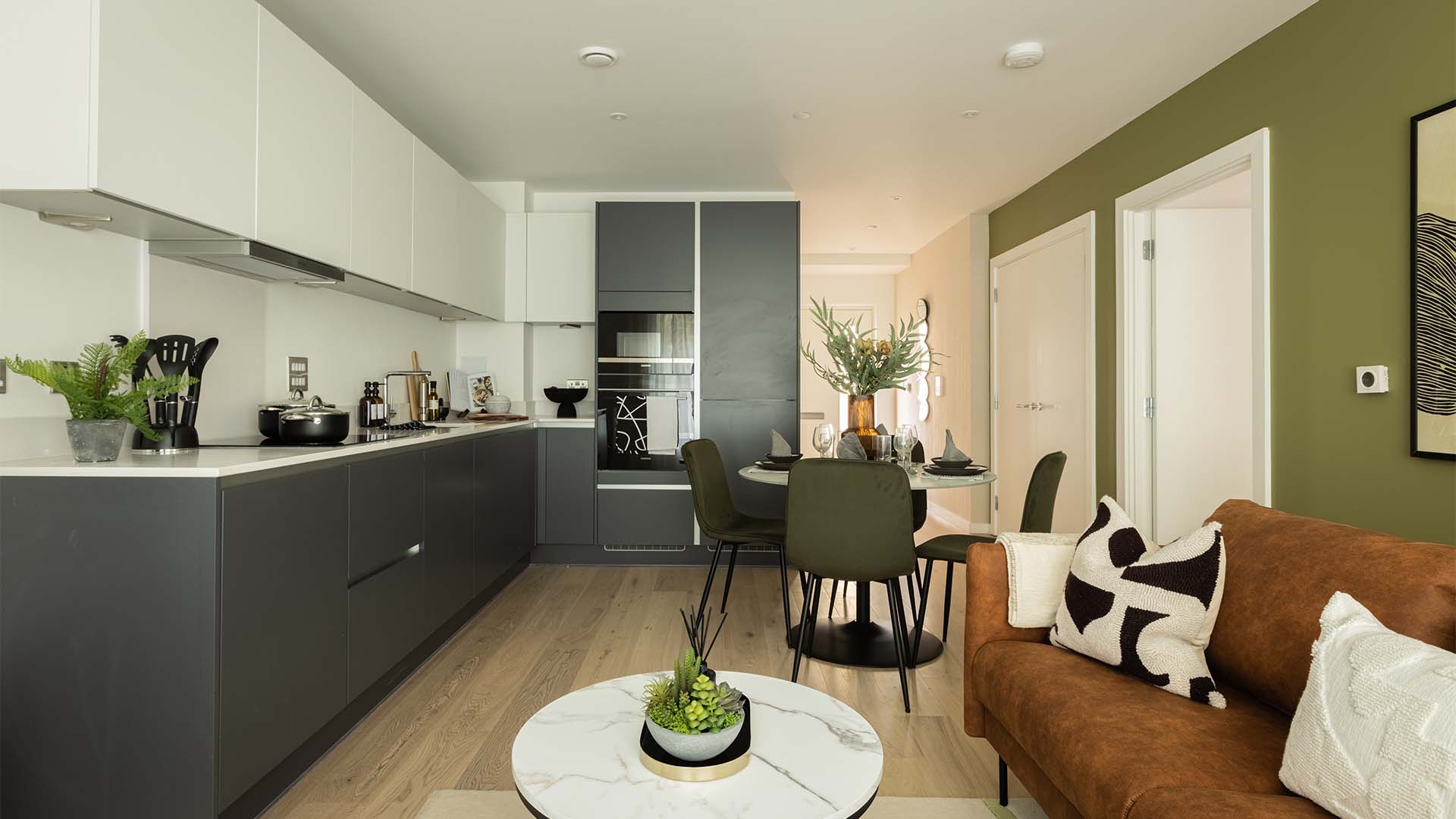 Kitchen with white cabinets and green accent wall-007