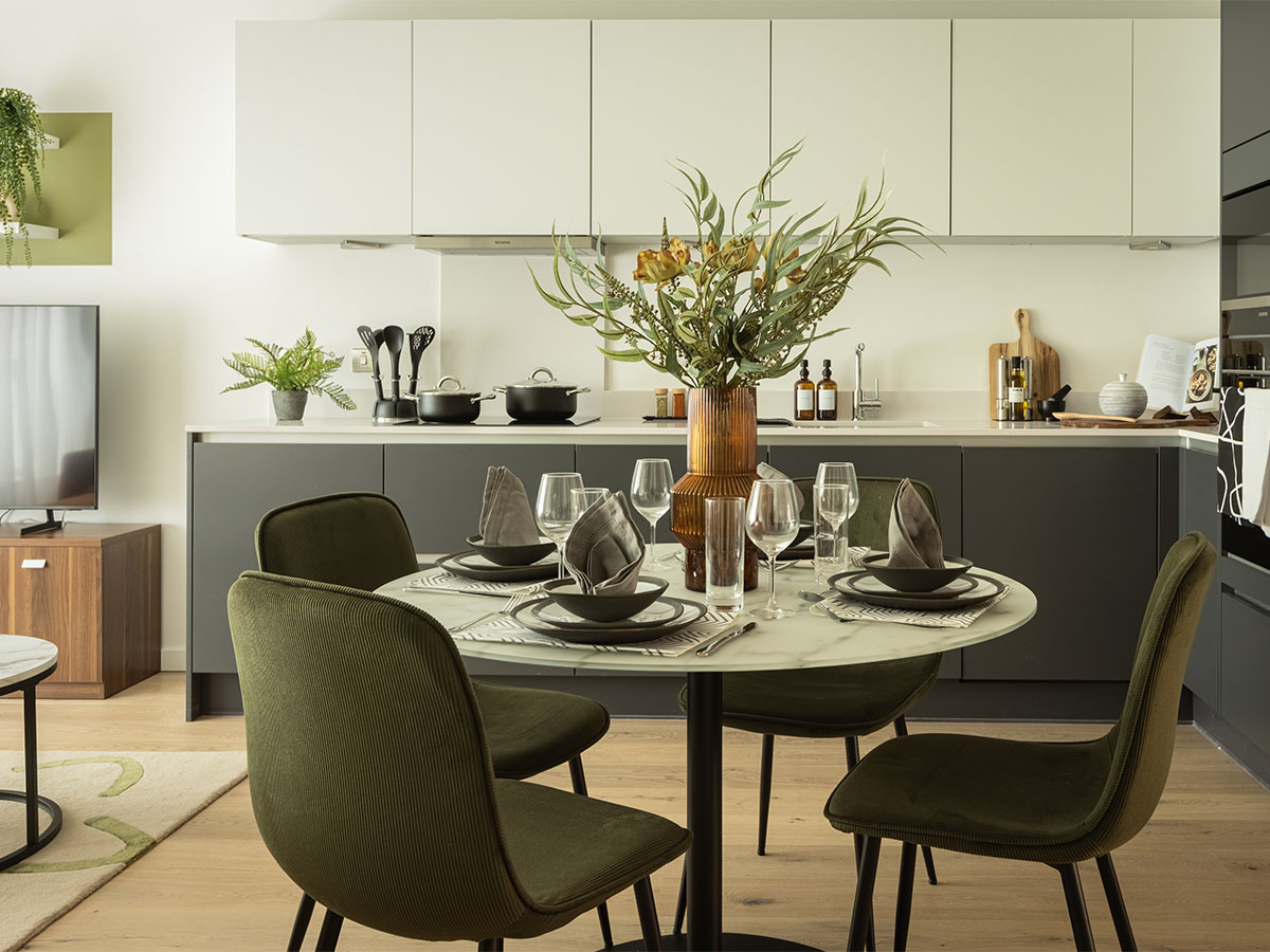 Modern kitchen with dining table and green chairs