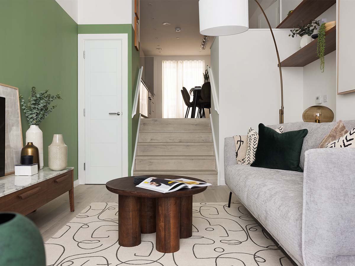 Modern living room with green accent wall and sofa